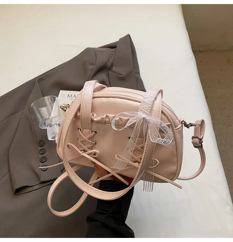 Women's casual PU shoulder handbag with bandage bow design in milky white colour showing sewing thread details
