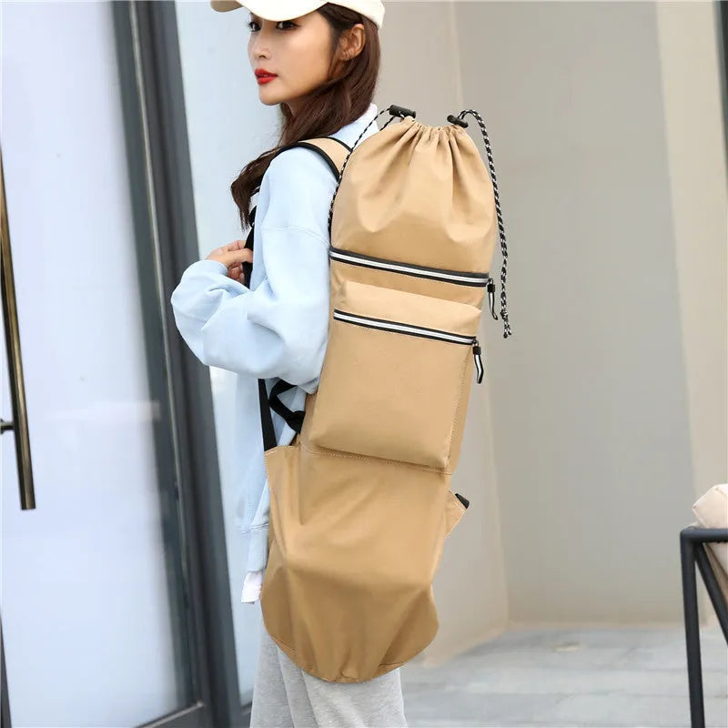 Roll-up skateboard bag in black nylon with an adjustable shoulder strap, shown carrying a skateboard.