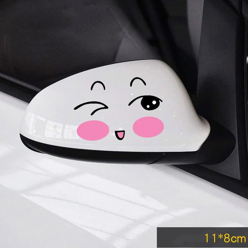 Pair of reflective cartoon eye car stickers on a vehicle rearview mirror and door panel.