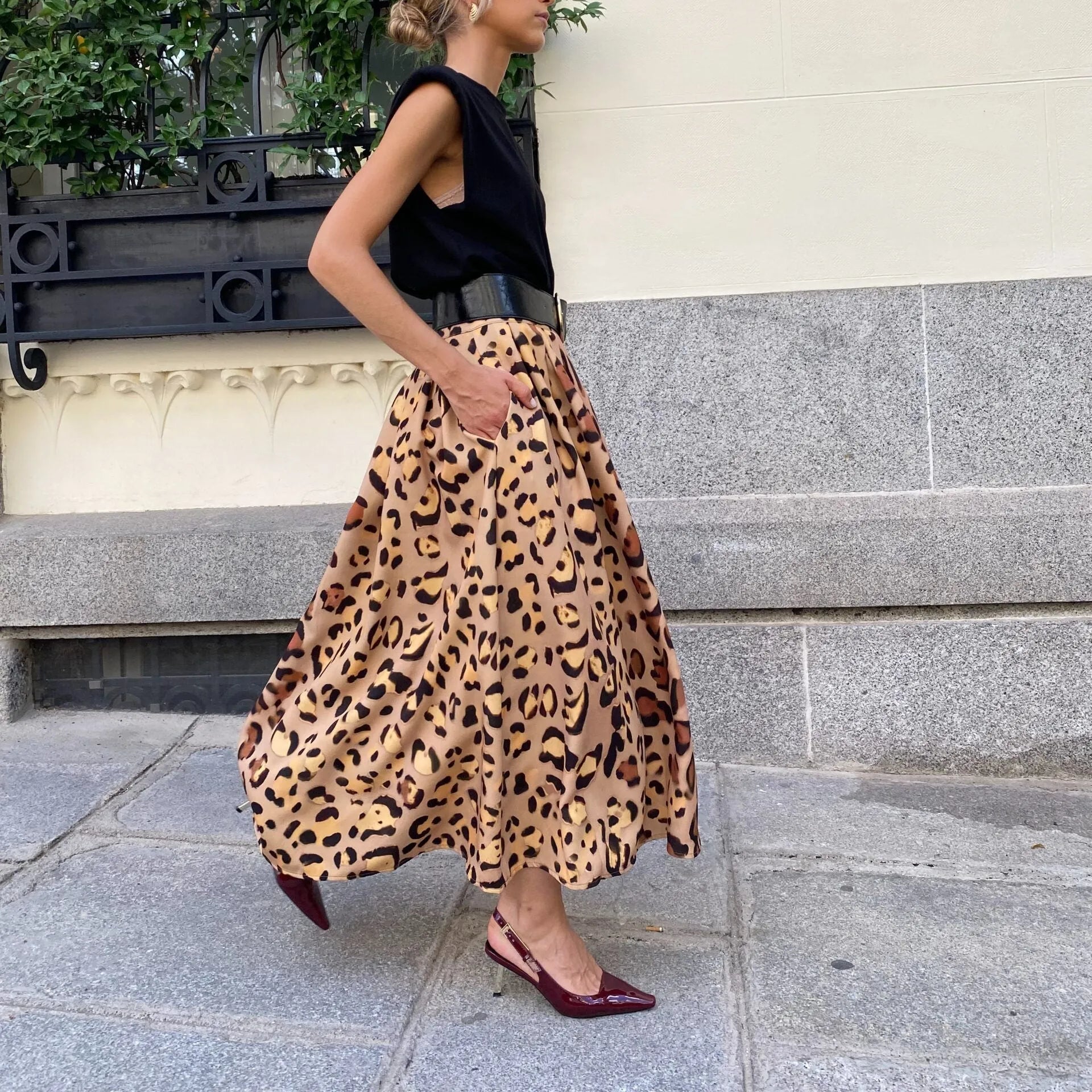 Brown leopard print women's long A-line skirt with a full hem on a hanger