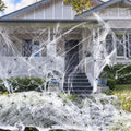 White cotton spider web Halloween decorations showing various weight packages with included plastic spiders