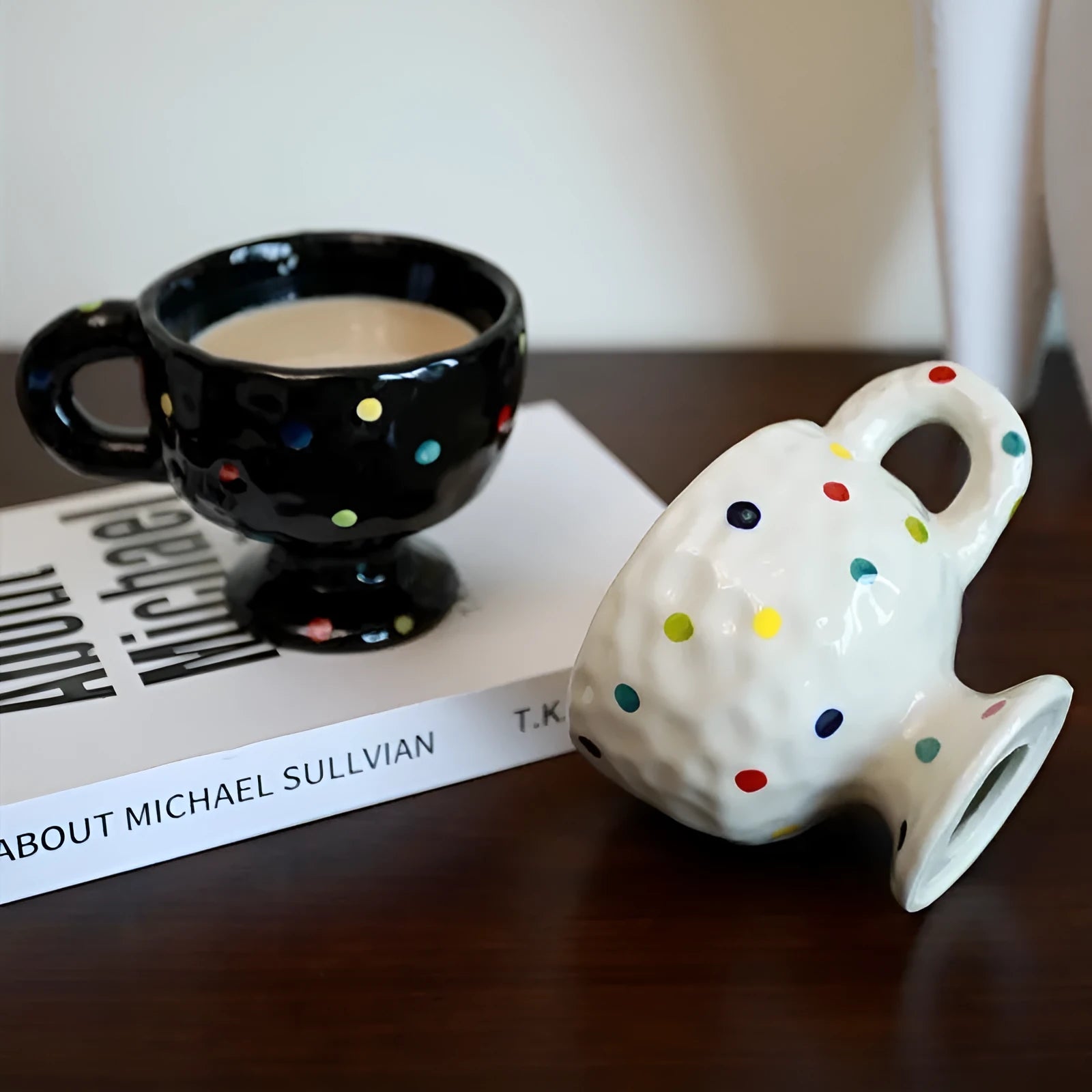 Hand-pinched irregular shaped ceramic mug in a solid colour on a plain background.