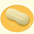 Yellow TPR peanut-shaped dog chew toy with textured shell on a white background.