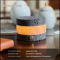 Small orange volcanic rock touch lamp with USB port and essential oil well in warm white.