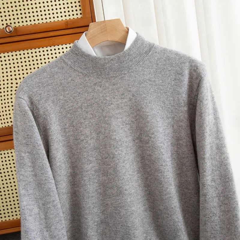 Man wearing a loose fit half-turtleneck wool sweater in a camel colour.