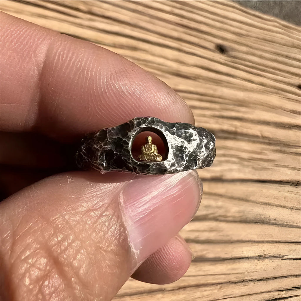 Hand-forged copper Buddha ring with grotto rock texture, shown on a size 8 finger.