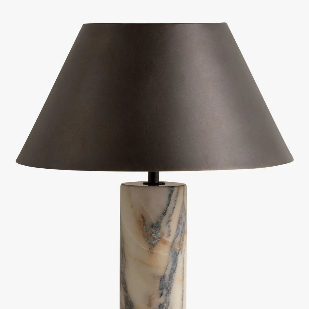 Modern black table lamp with a textured marble base on a wooden desk.