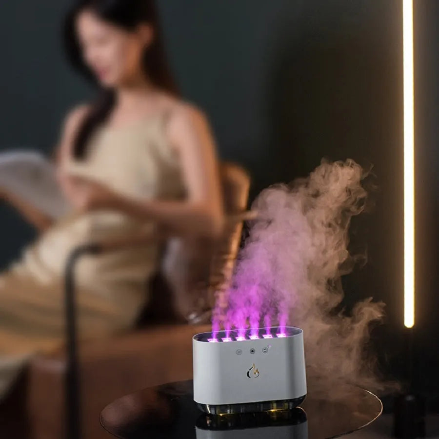 White large-capacity humidifier with colourful LED atmosphere lamp and aromatherapy diffuser on a table.