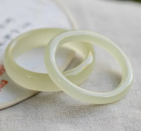Round bar jade bracelet showing natural stone patterning with size measurement guide