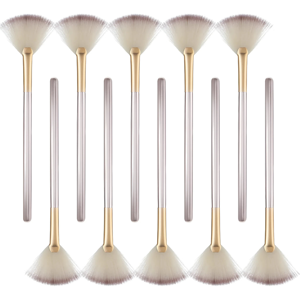 Set of 10 champagne-coloured facial fan brushes with wooden handles on a white background.