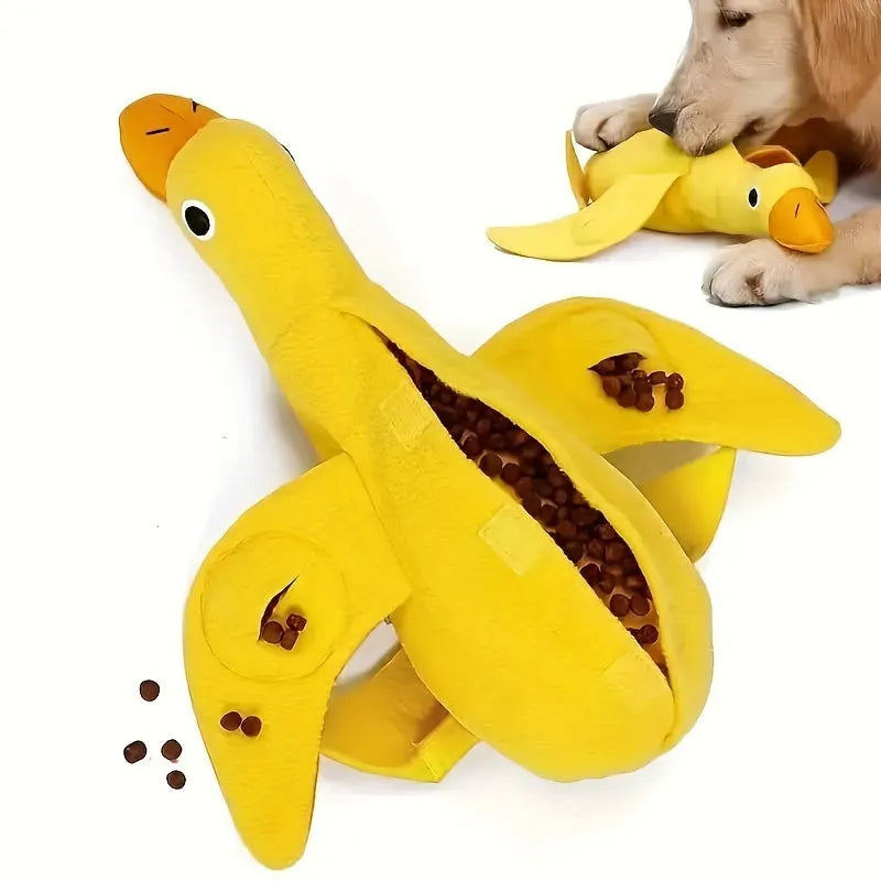 Yellow rubber duck dog toy with squeaker and treat compartment for puppy training and teething.