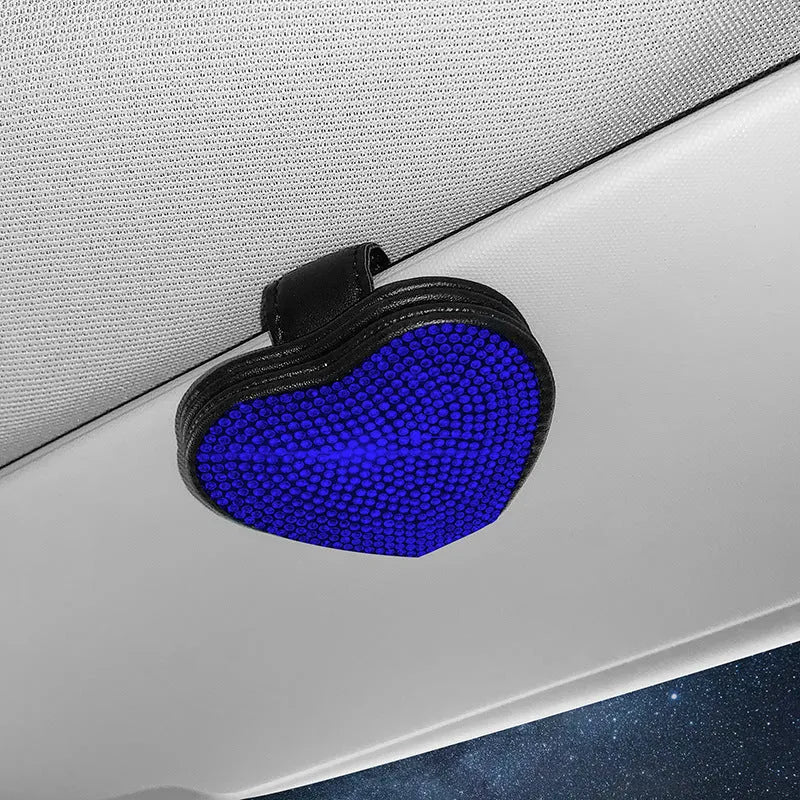 A black PU leather magnetic storage clip with a diamond pattern on a car sun visor, holding a pair of sunglasses.