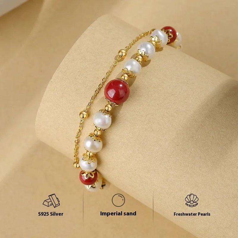 Sterling silver double layer bracelet with cinnabar red beans and white freshwater pearl charms