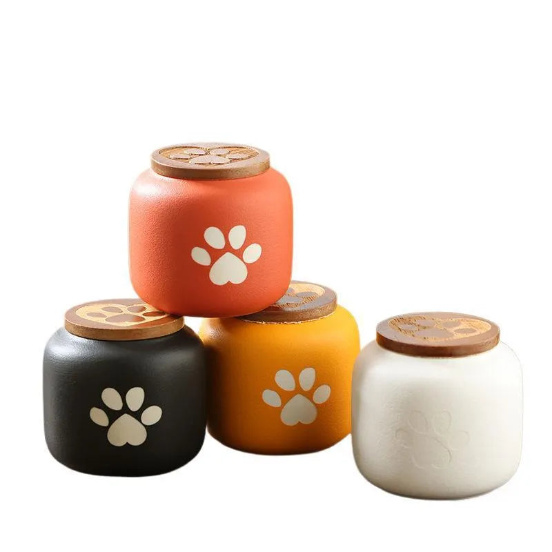 Ceramic pet funeral urn with foot print design in orange colour