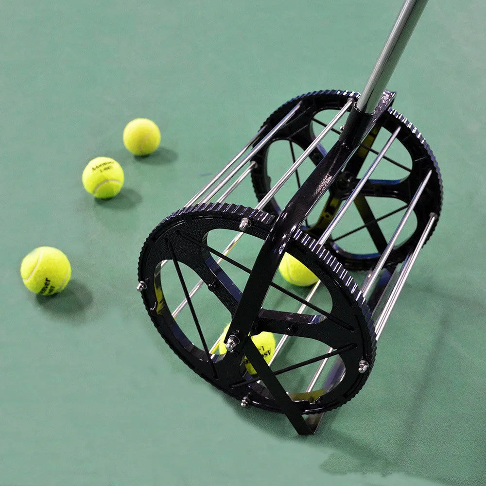Black tennis ball picker basket made from nylon and metal, holding multiple tennis balls on a court