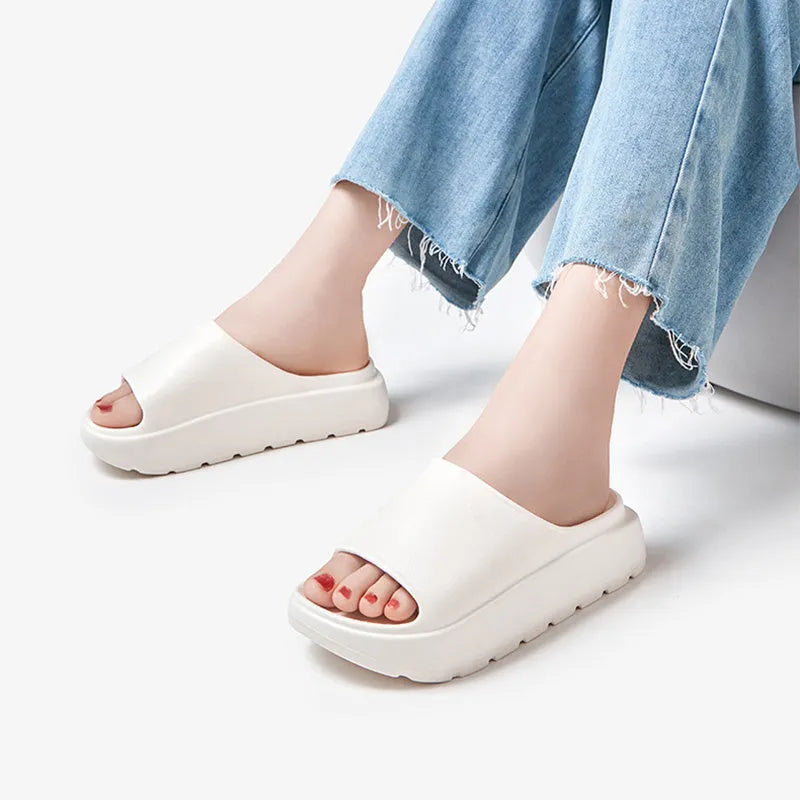 Women's thick-soled beach slippers in beige with a textured EVA sole.