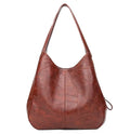 Vintage women's large PU shoulder tote bag in solid colour with double straps and magnetic buckle closure.