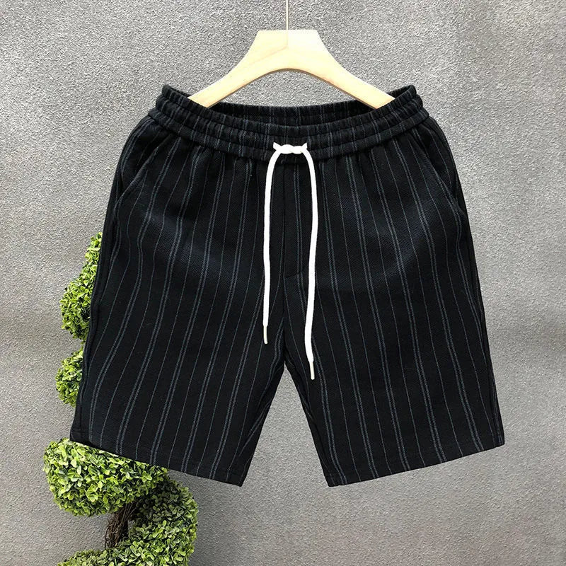 Men's black and white striped fleece-lined casual shorts showing straight leg and ankle band design.