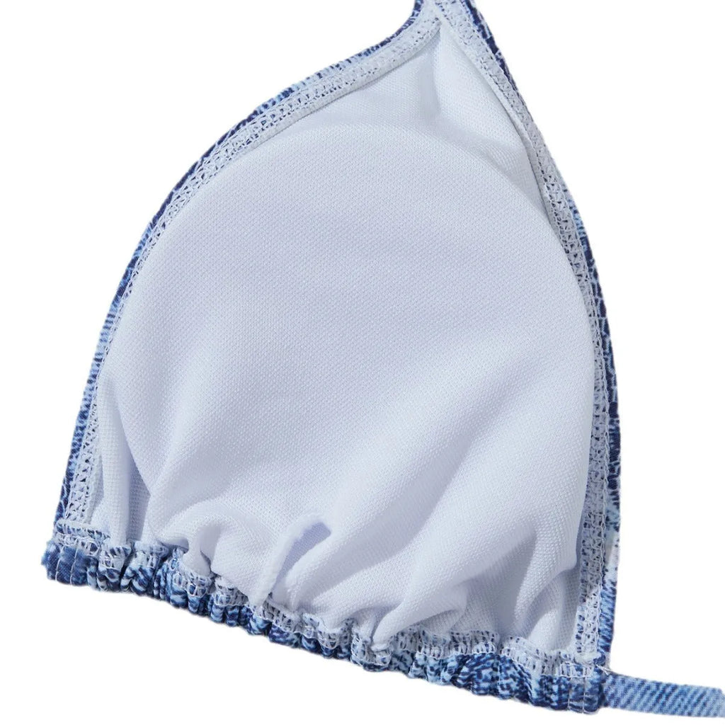 Women's denim blue printed bikini set with adjustable straps on a mannequin.