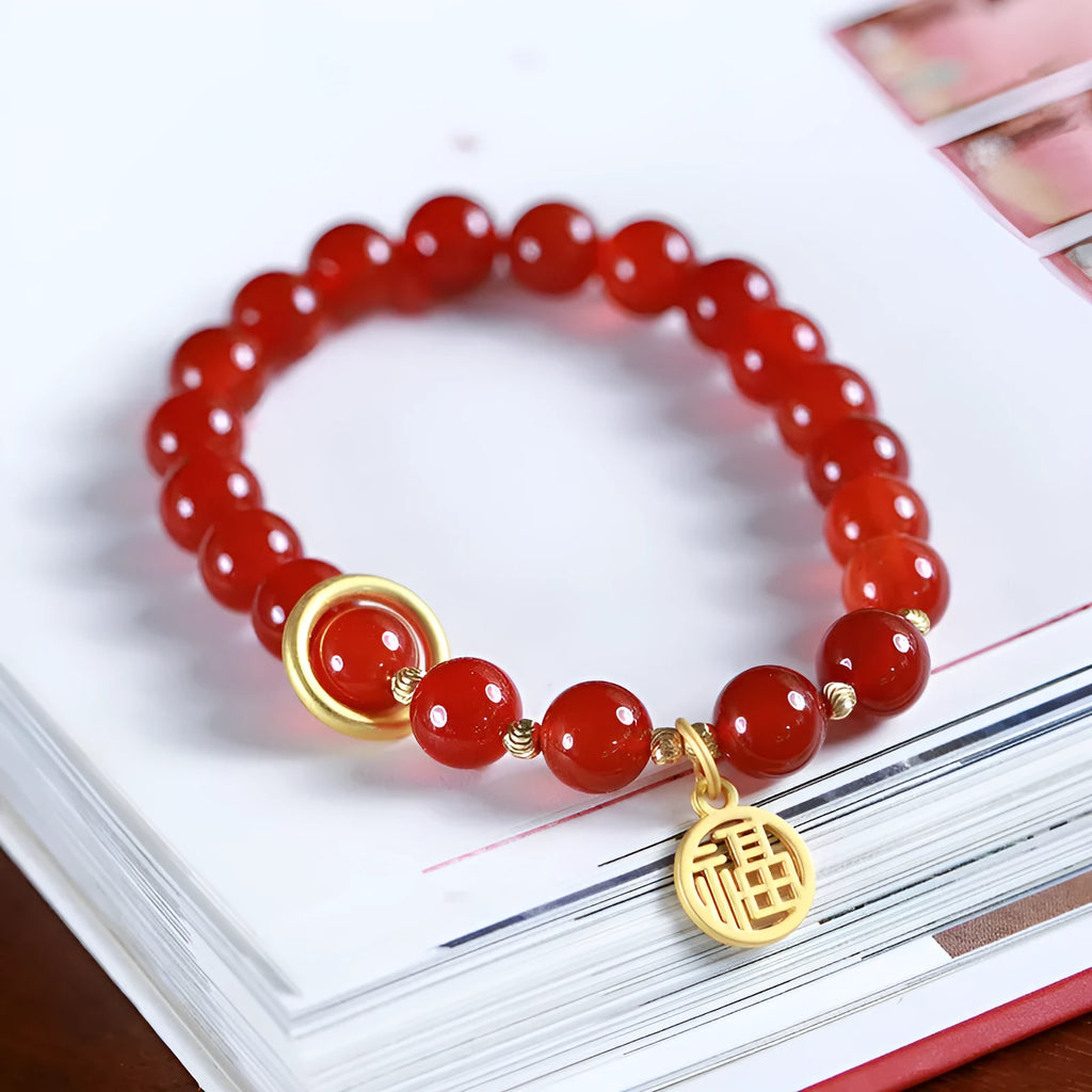 Natural red agate bracelet with woven bead design on a wrist.
