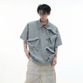 Men's loose fit polo shirt with deconstructed shirt collar and geometric pattern in grey.