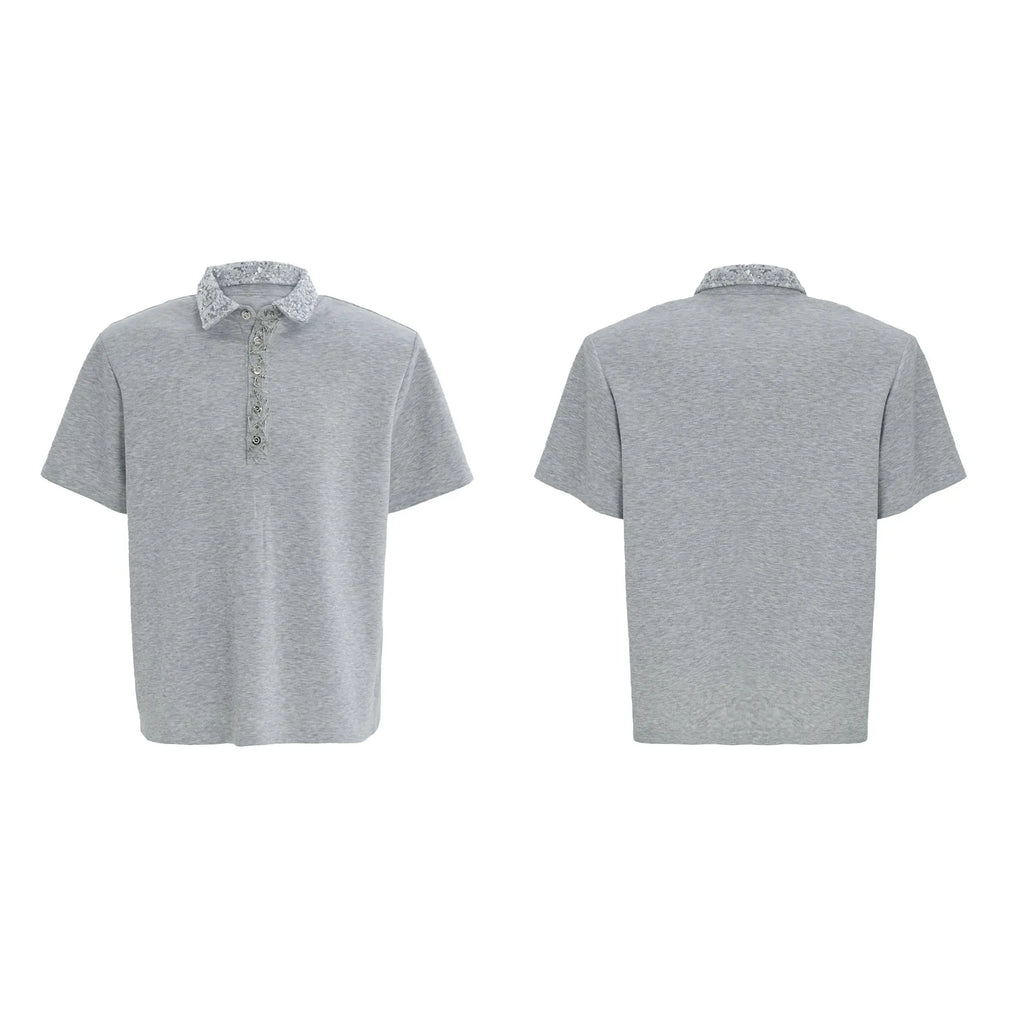 Men's black loose-fit polo shirt with front embroidery and sequin detail on a square collar.