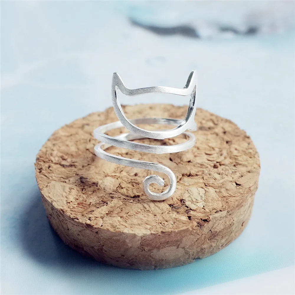 S925 silver adjustable cat ring with brushed winding collar detail on light background