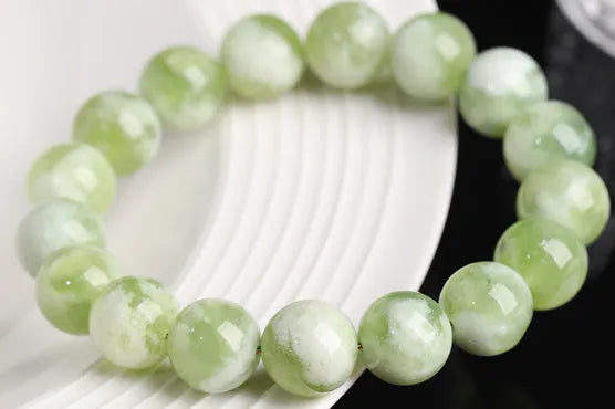 Green milk-in-water Xiuyan jade bracelet with geometric beads and polished finish