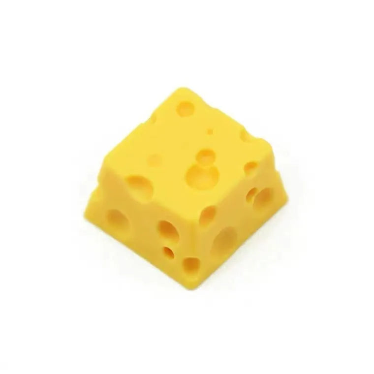 Yellow resin mechanical keyboard keycap sculpted like a wedge of Swiss cheese.