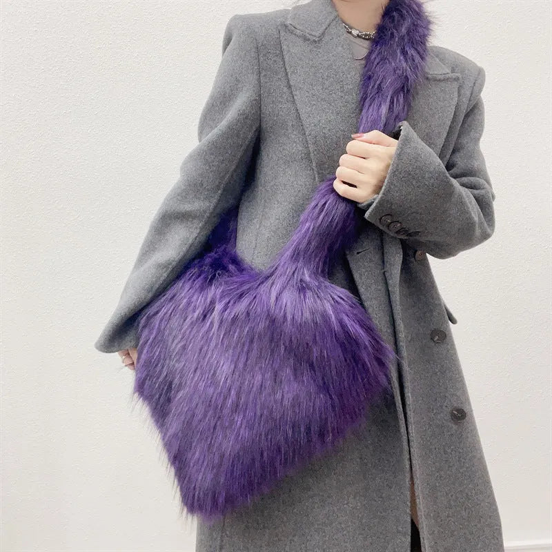 Women winter fleece heart shape crossbody bag with plush exterior, tassel detail, and large capacity