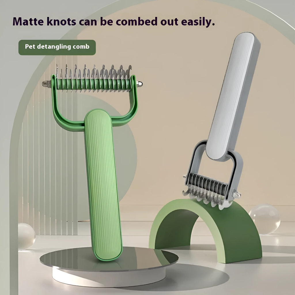 Green and grey dog grooming unknotting comb with stainless steel pins on a plastic handle.