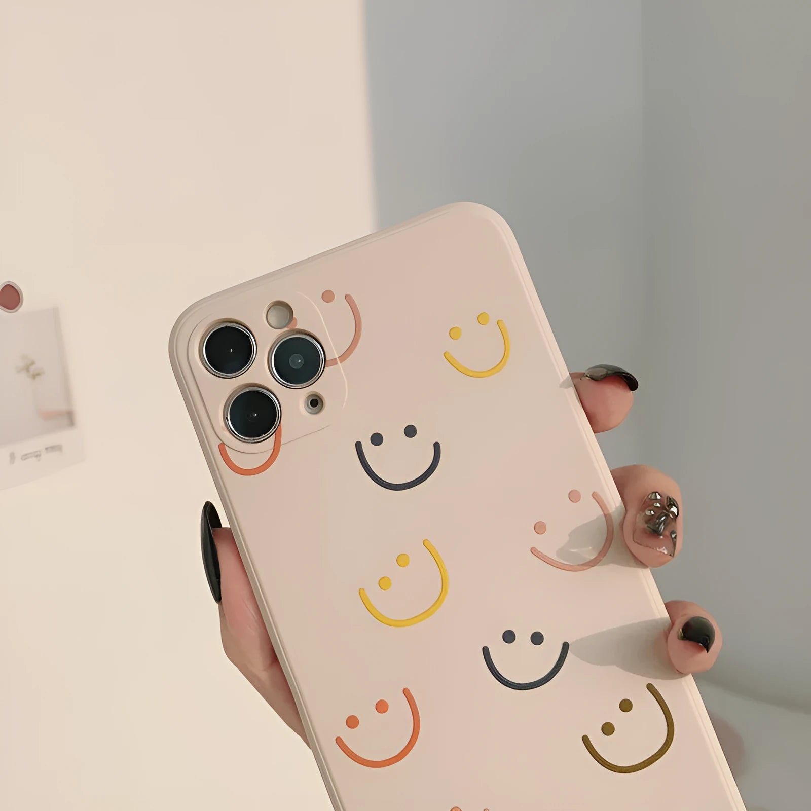 Simple silicone iPhone case with smiley face design in multiple colour options