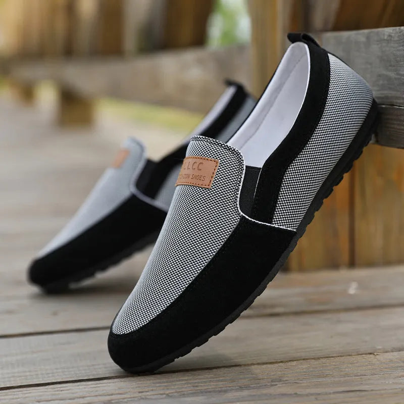 Men's grey canvas casual board shoes with round toe design and rubber soles shown from side view