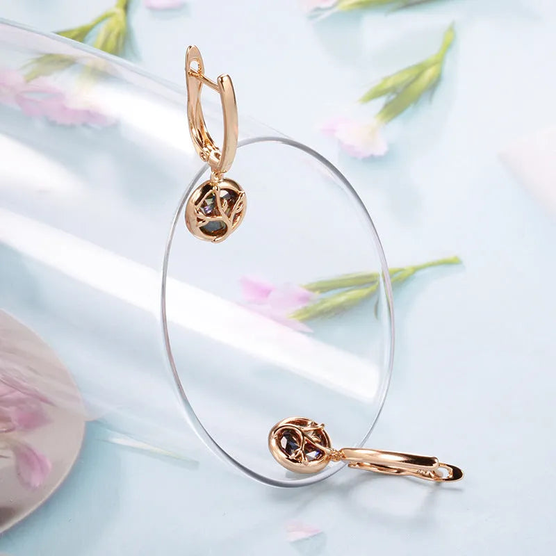 Rose gold plated copper drop earrings with artificial gemstone inlay on white background