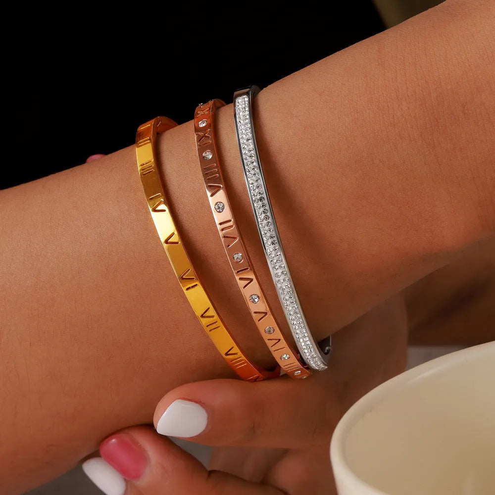 Retro Roman numeral titanium steel gold-plated bracelet with diamond accents on wrist