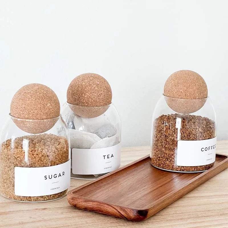 Three transparent glass spherical food storage tanks arranged on a shelf with modern simple design