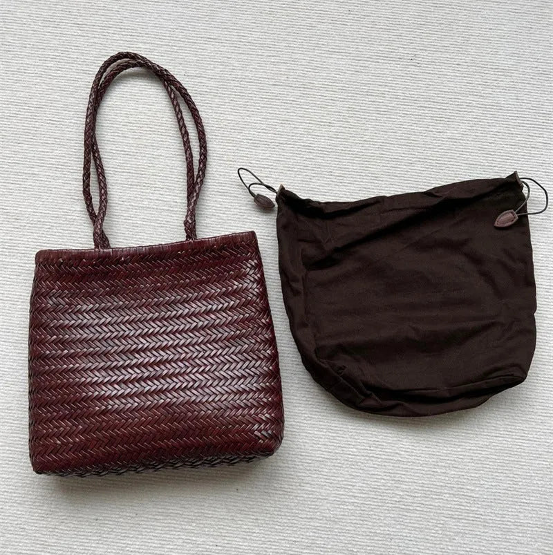 Brown vintage woven leather tote bag with a three-dimensional front pocket.