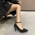 Women's black stiletto heel pump shoe with a skull pattern and buckle detail on a white background.
