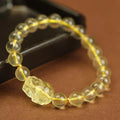 Yellow leather adjustable bracelet with a citrine Pi Xiu crystal charm in Chinese simple style.