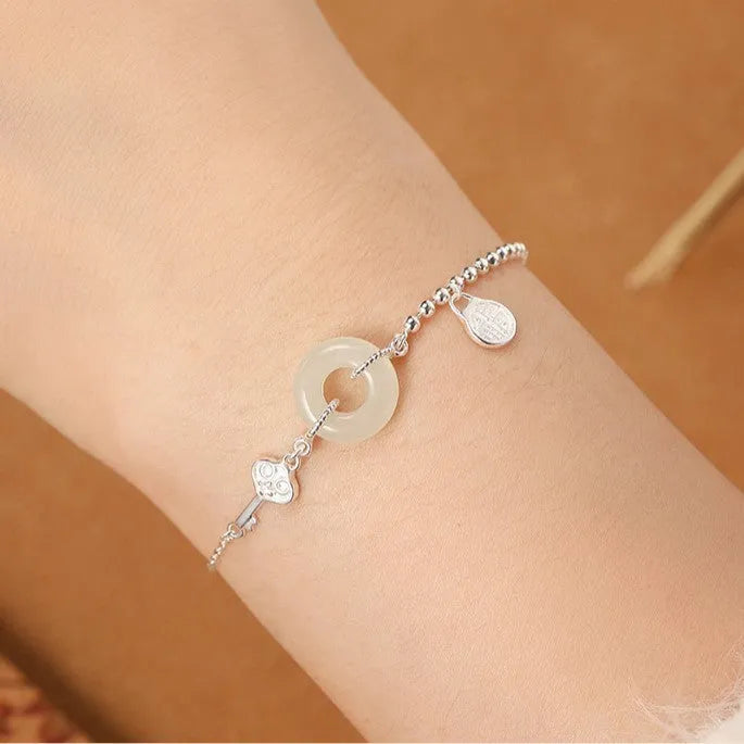 Women's silver bracelet with Hetian jade and geometric peace buckle design in Chinese style