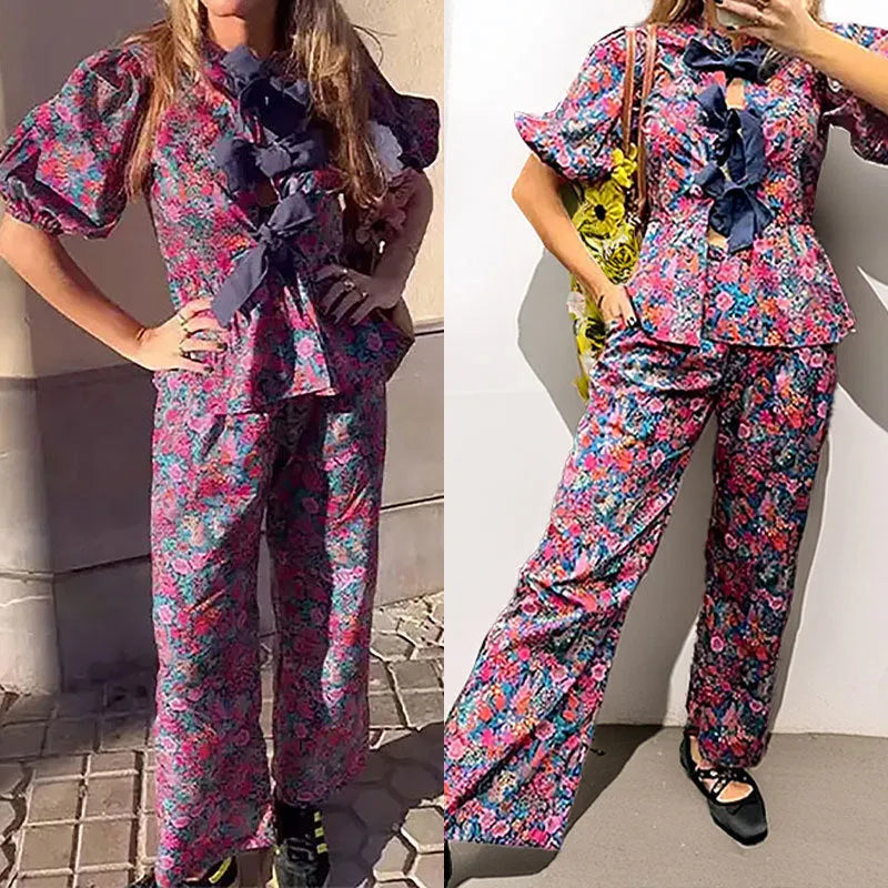Women's floral print trouser suit with puff sleeves and tie-neck top, coordinating trousers