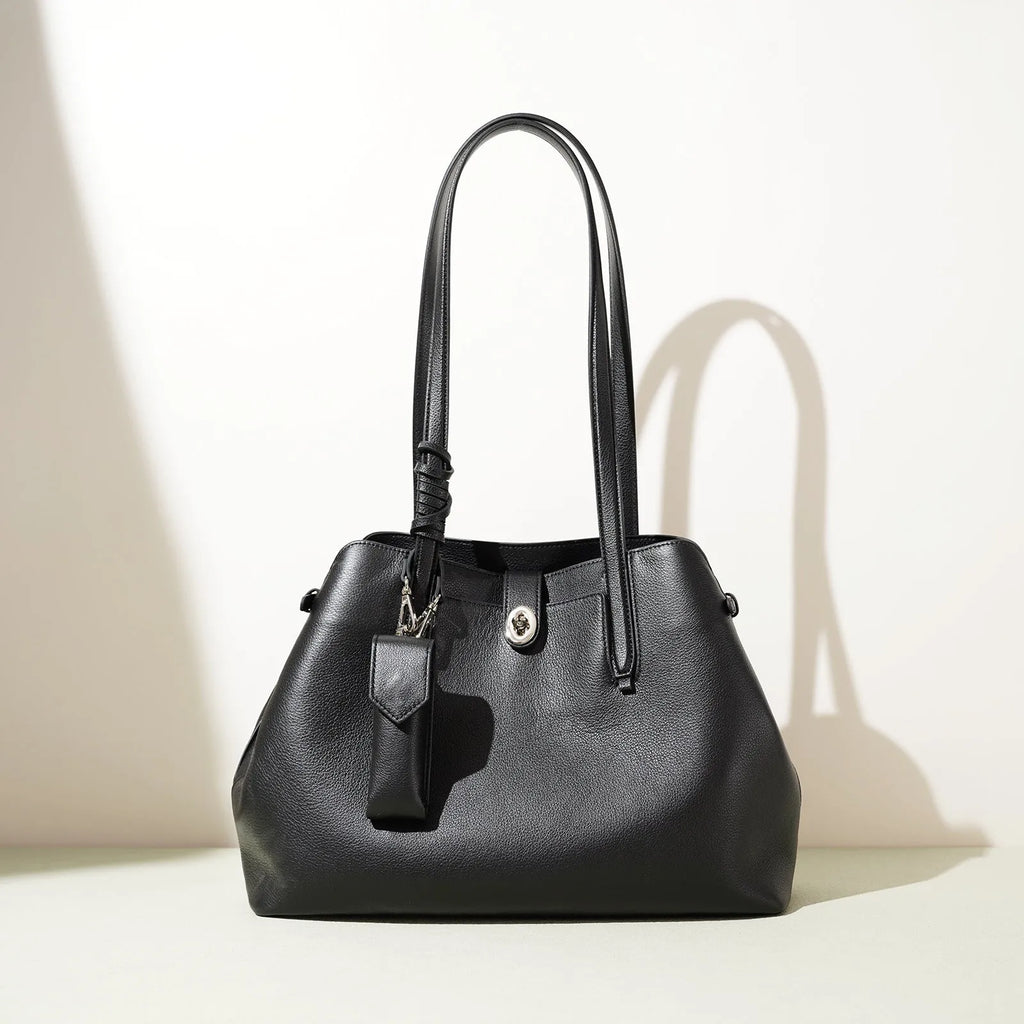 Large capacity genuine leather bucket bag for women in black with crossbody strap and patchwork detail