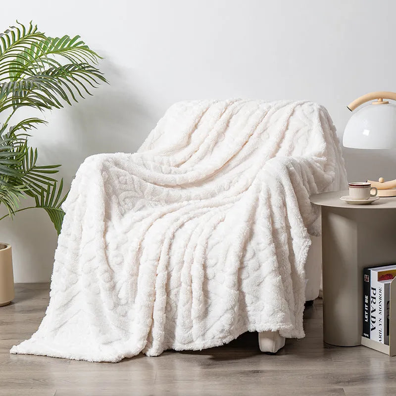 Velvet jacquard sofa throw blanket in a solid colour with woven plant flower pattern, shown in fog blue.
