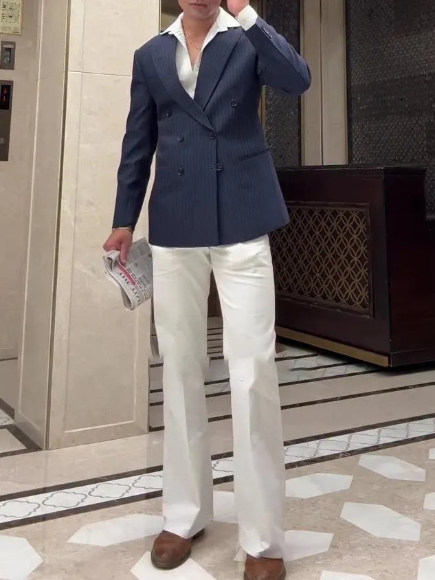Men's striped double-breasted polyester blazer on hanger showing regular fit design