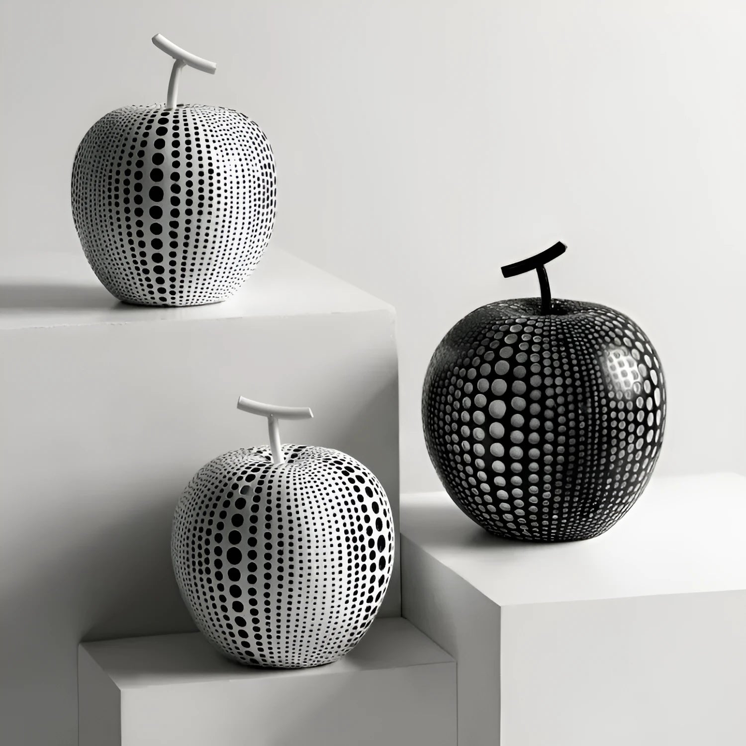 Solid resin apple figurine with smooth apple finish, 17cm high, in black colour on a shelf