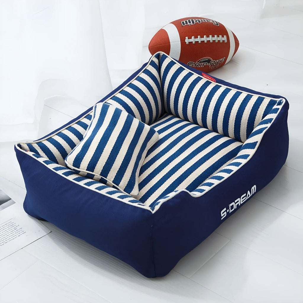 Navy stripes washable dog kennel mat with removable fabric pillow in a pet crate.