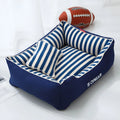 Navy stripes washable dog kennel mat with removable fabric pillow in a pet crate.