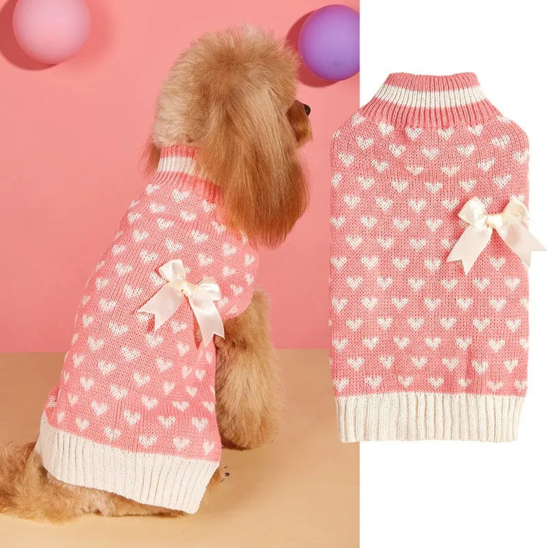 Dog wearing acrylic sweater with embroidered bow and heart patterns