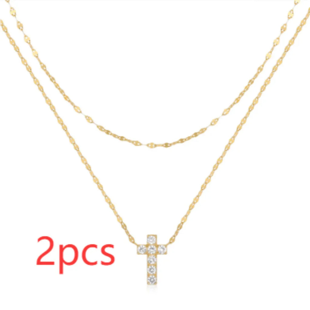 S925 sterling silver double layer cross pendant necklace with diamond cut detail on a clavicle chain.