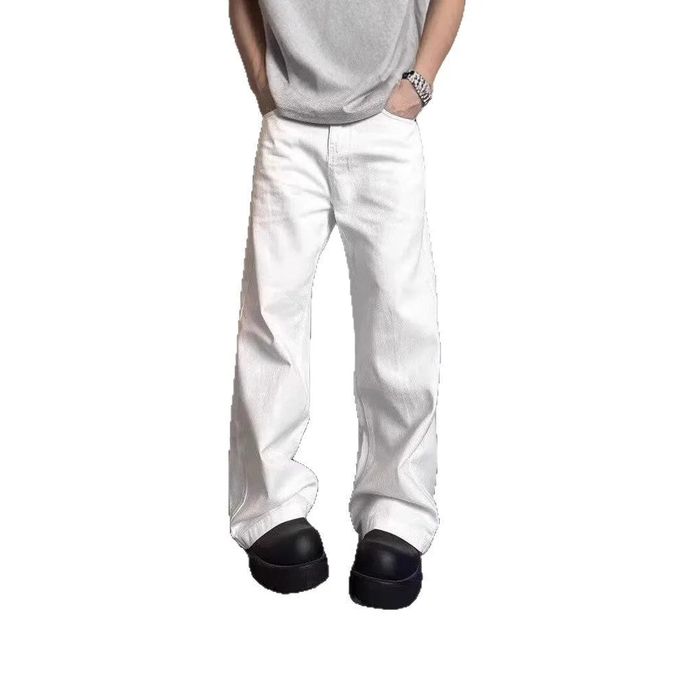Men's white straight-leg denim jeans with a wide fit and mid-rise waist on a plain background.